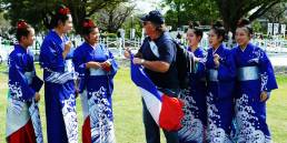 French Rugby fan interacting with Japanese girls in kimonos outside Kumamoto Castle