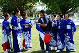 French Rugby fan interacting with Japanese girls in kimonos outside Kumamoto Castle